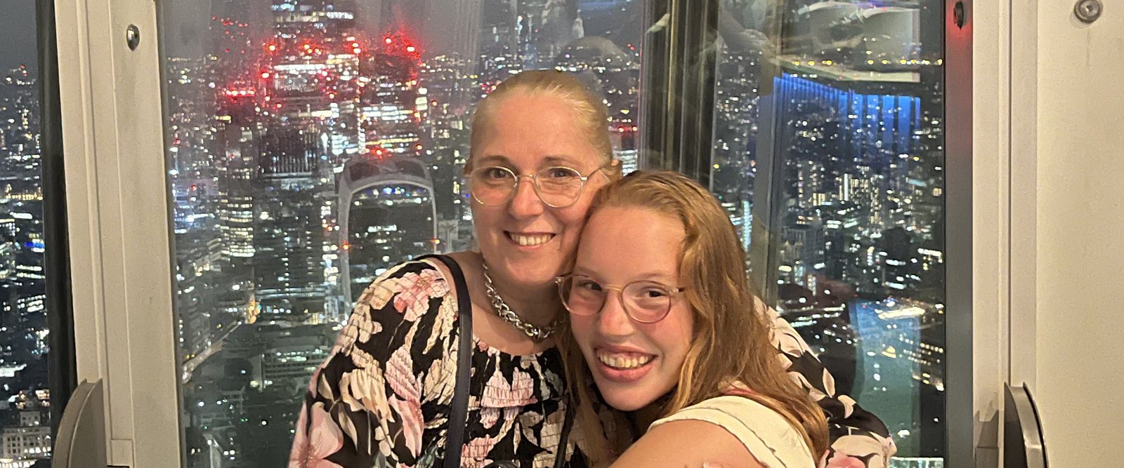 Another hug at The Shard, this time in the evening with the skyline behind them.