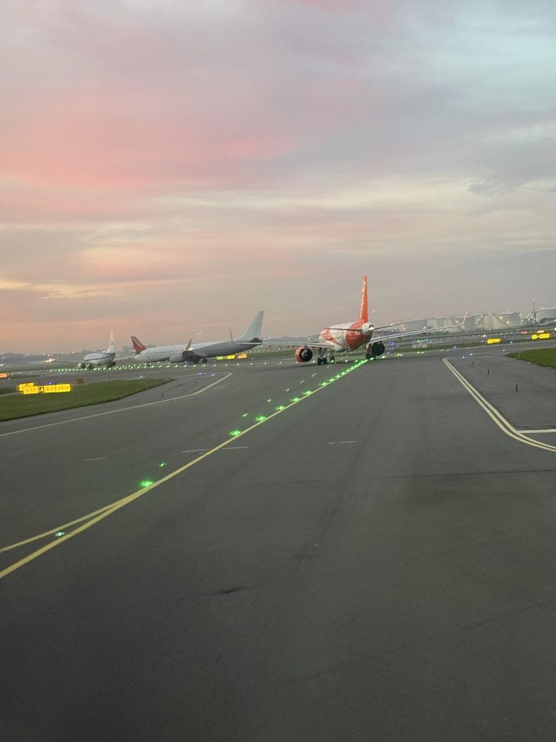 Taxiing under a pink morning sky.