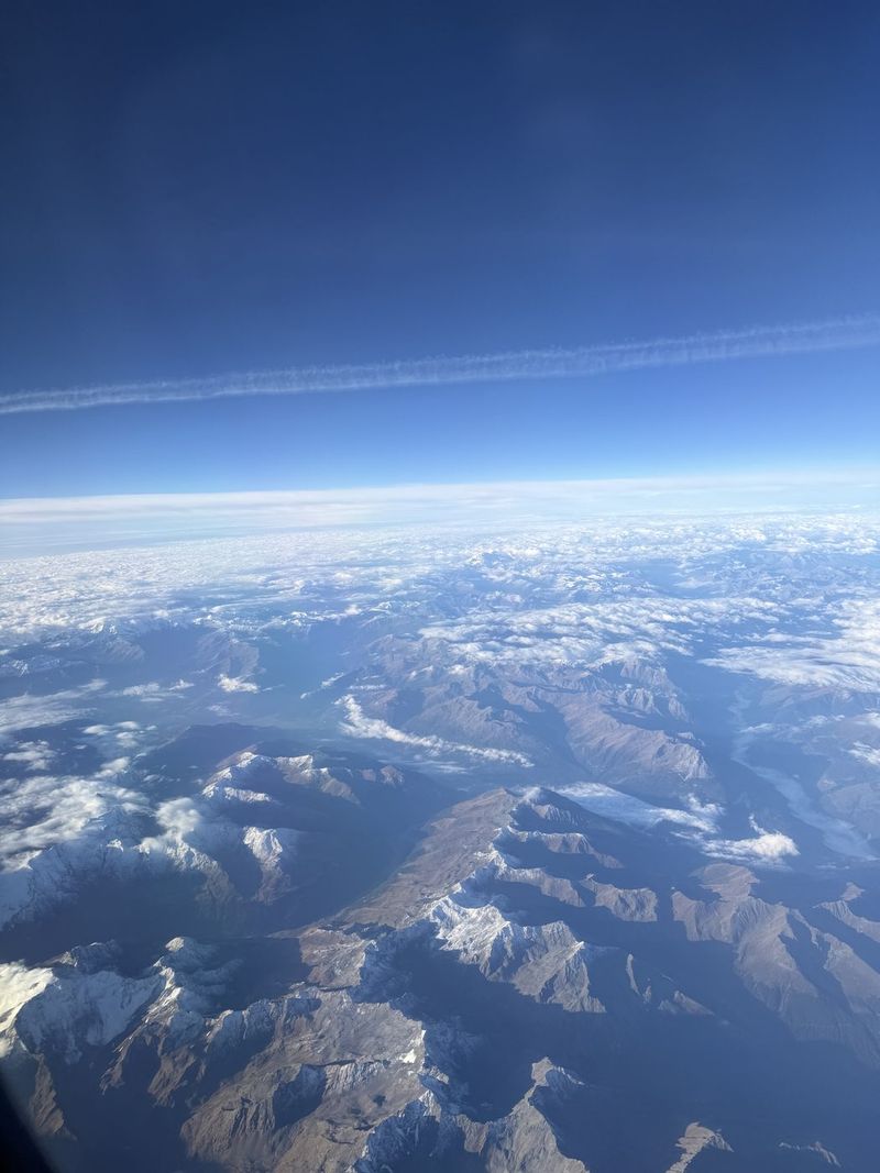 Over the Alps, with the first snow on the peaks.