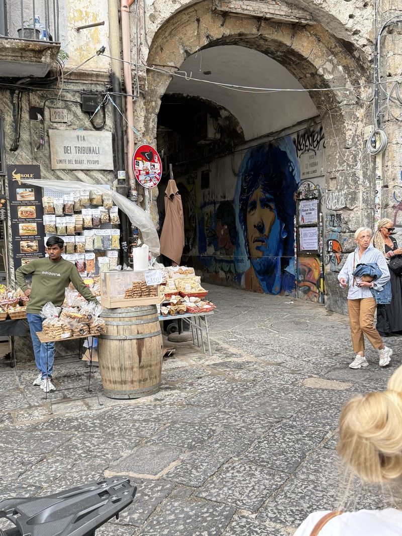An old archway on Via dei Tribunali, with Maradona on the wall.