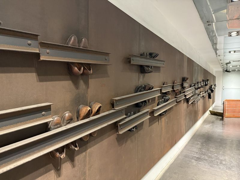Back in town: an artwork of shoes on railway tracks in Dante metro station.