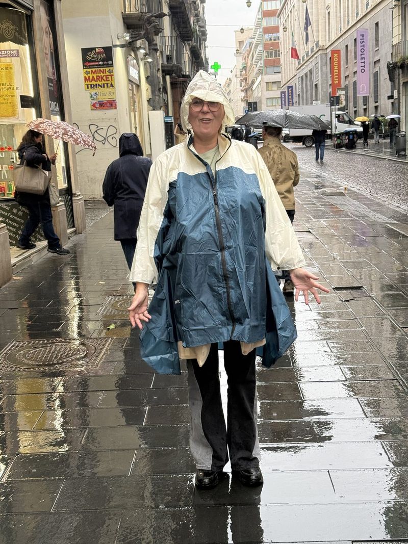 Liek in her poncho on Via Toledo. Ponchos and umbrellas are definitely coming along today!