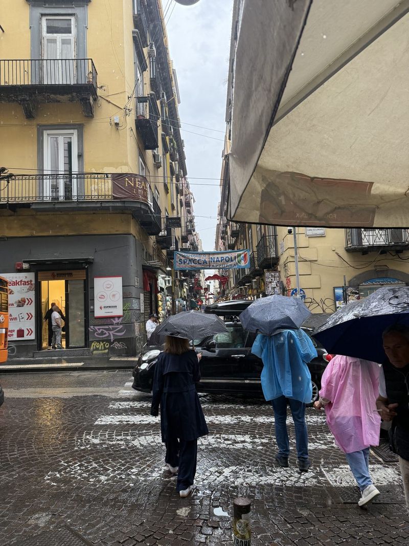Ponchos and umbrellas in every colour at the crossing.
