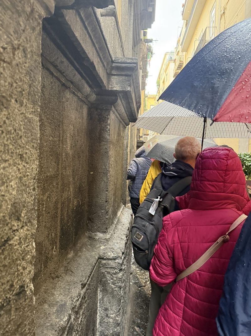 Under the umbrella along the wall to the entrance. Inside you are not allowed to take photos yourself.