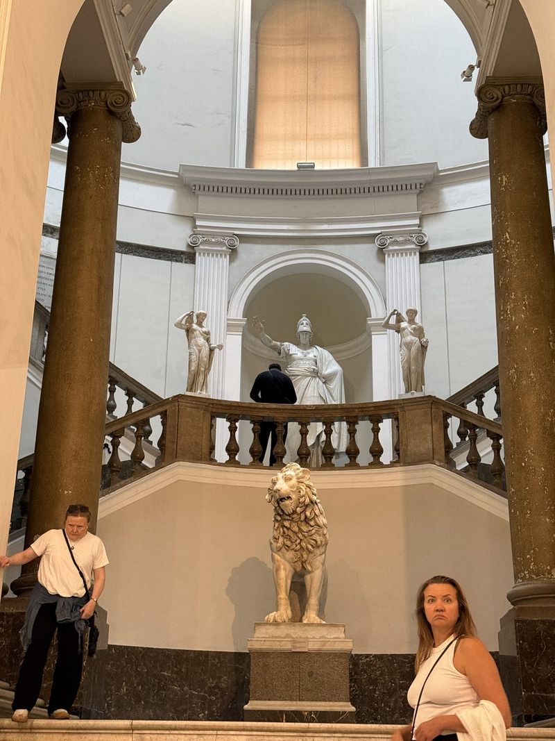 The monumental staircase, with a marble lion at the bottom.