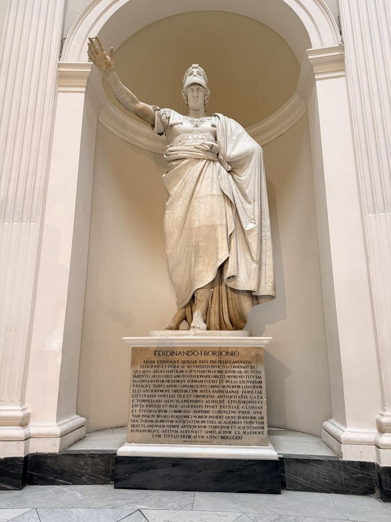 A large marble statue in a niche on the staircase.